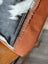 Rustic oakley bag cushion with black and white real cowhide pattern and brown leather trim for spacious bag style