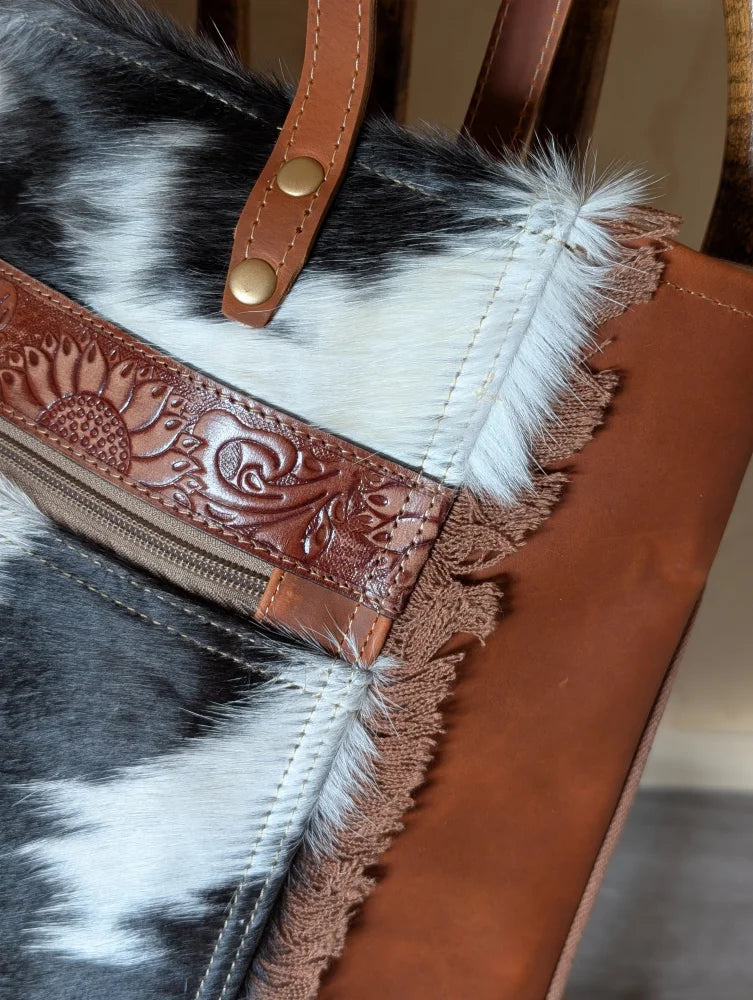 Brown leather strap with floral embossing and gold hardware accented by frayed real cowhide on #2 oakley bag