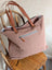 A spacious oakley specks canvas tote bag in soft dusty rose with real cowhide tan leather handles and zipper pull