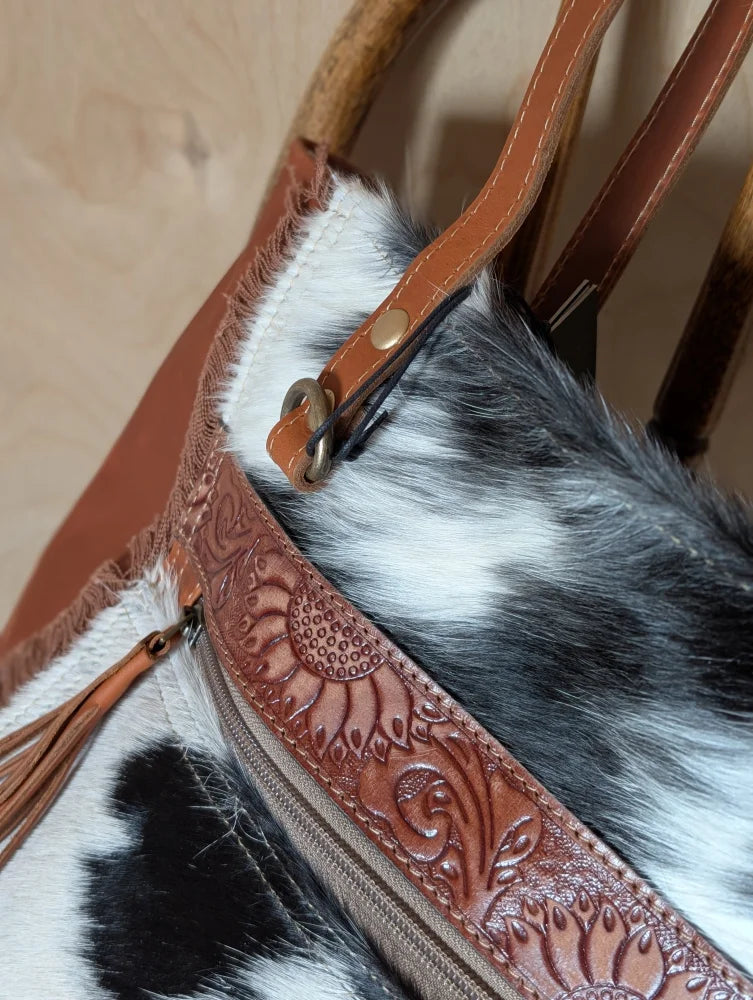 Brown leather strap with floral embossing and brass clasp on real cowhide oakley specks canvas spacious bag