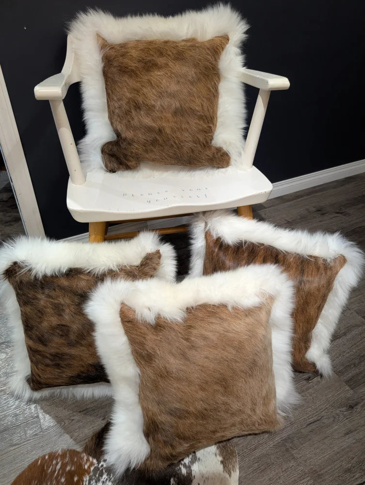 Brown cowhide merino sheepskin cushion with plush white fur trim perfect for cozy home decor