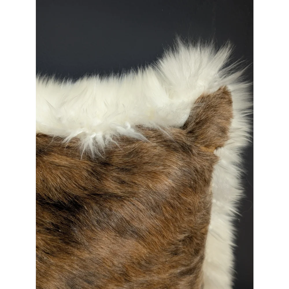 Brown and white faux fur merino sheepskin cushion with plush textured surface in cowhide merino sheepskin style