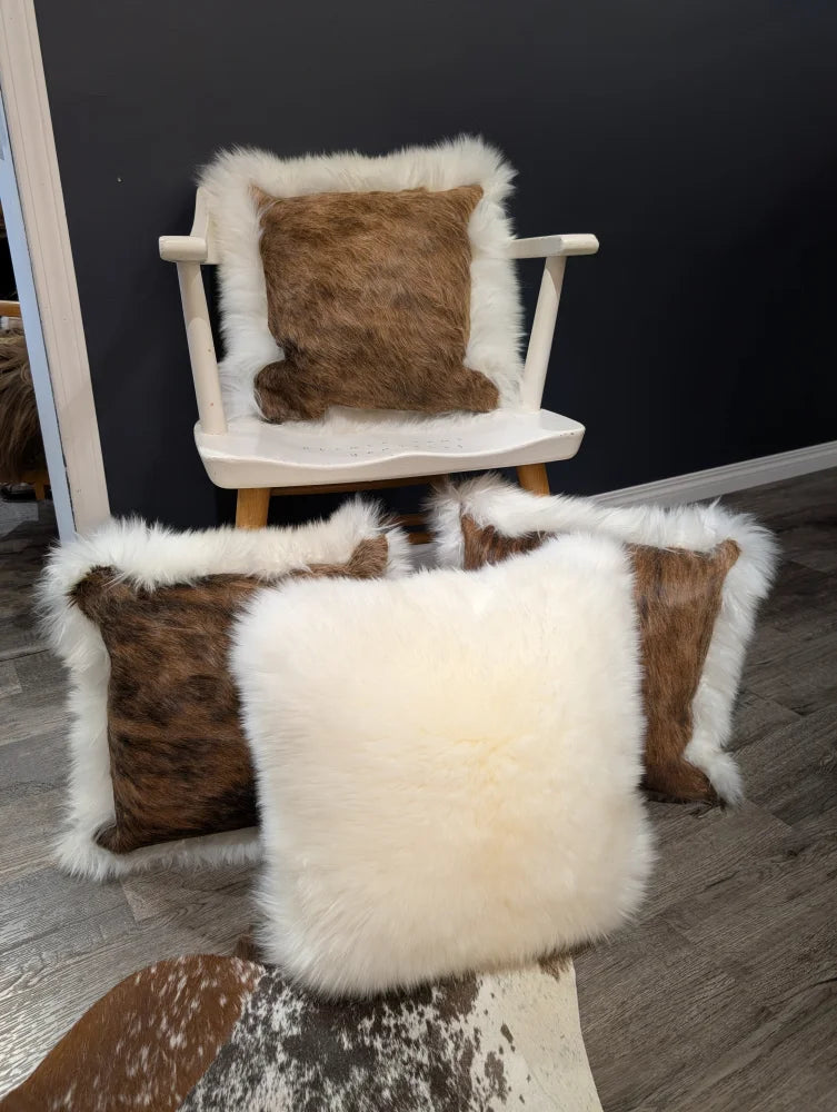 White and brown cowhide merino sheepskin cushion with fluffy textured edges perfect for cozy decor
