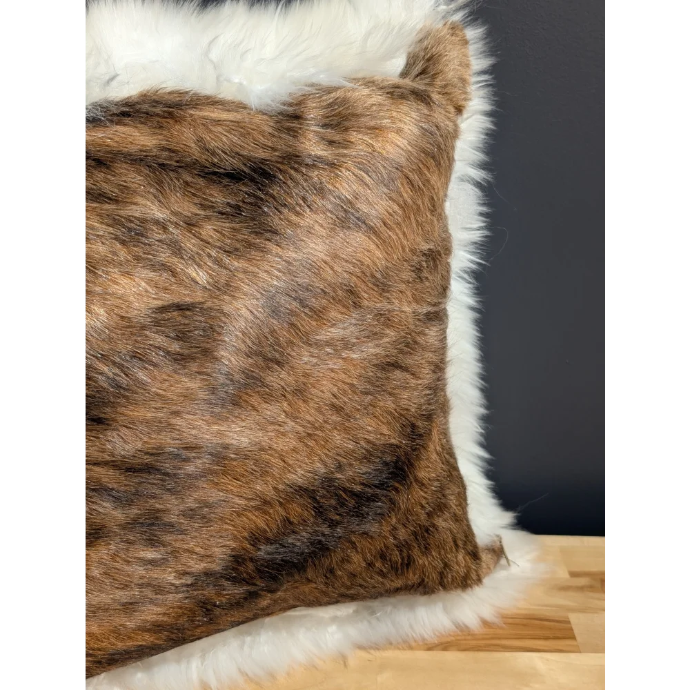 Brown and black cowhide merino sheepskin cushion with plush white fur trim for cozy home decor