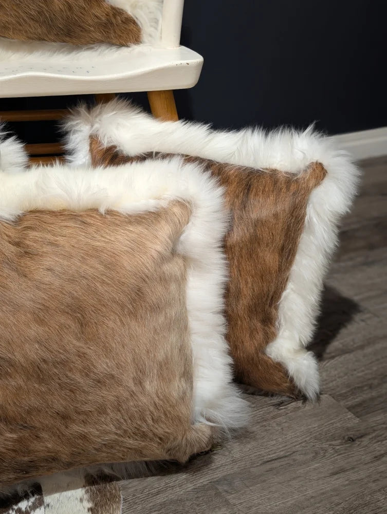 Brown and white cowhide merino sheepskin cushion with fluffy natural fur trim perfect for cozy home decor
