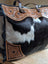 #2 the sunflower weekender bag is a black and white hair-on hide tote with tan cartwright hand-tooled leather and brown handles