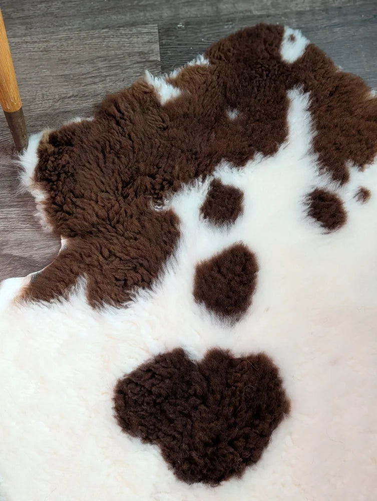 Brown and white highland spotted grade a- sheepskin rug perfect for cozy home decor and comfort