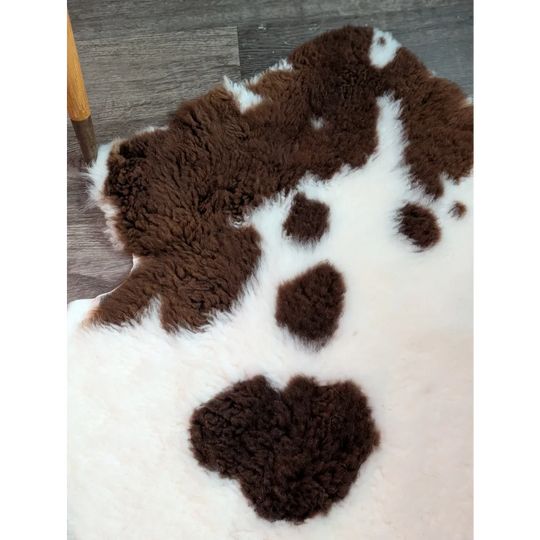 Brown and white highland spotted grade a- sheepskin rug perfect for cozy home decor and comfort
