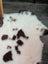 A fluffy white and brown spotted tibet highland spotted grade a- sheepskin rug with a soft natural texture