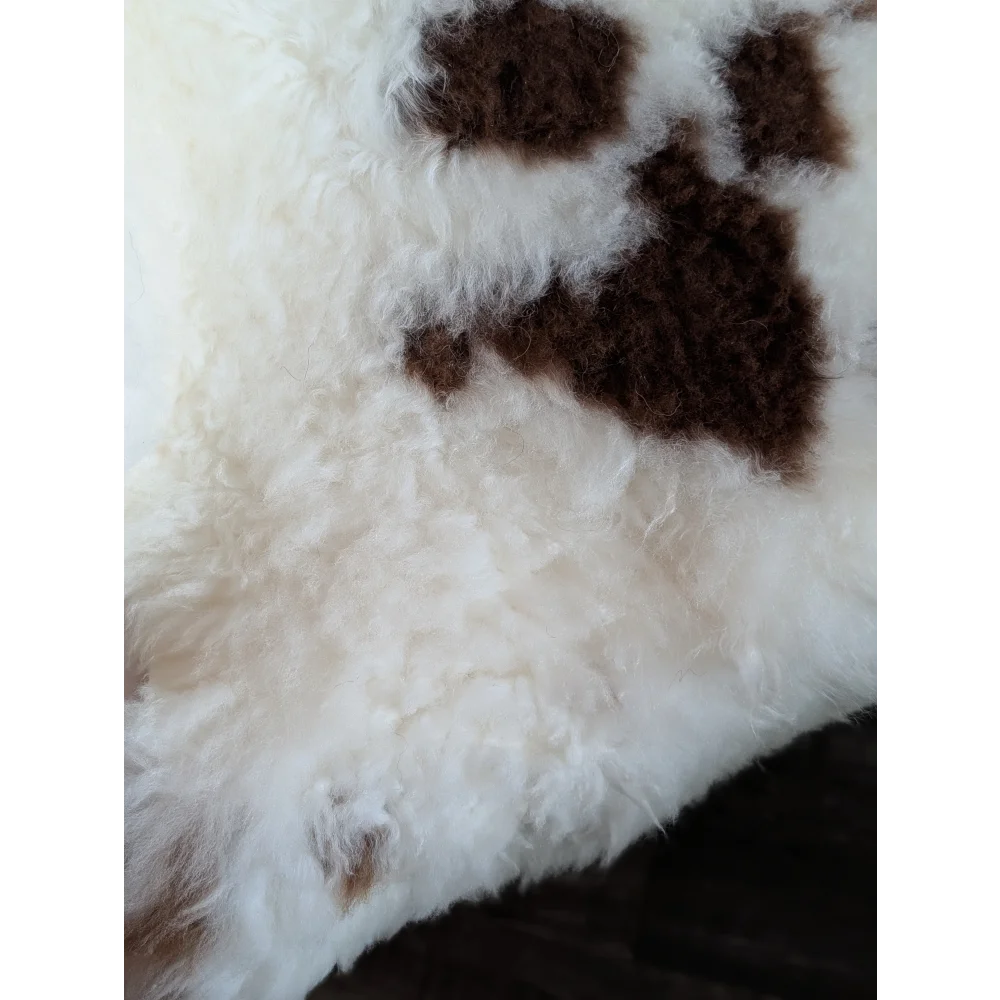 White and brown tibet highland spotted grade a- sheepskin rug with curly fur and paw print design