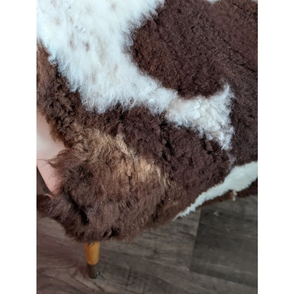 Brown and white highland spotted grade b sheepskin rug with plush curly texture perfect for cozy decor