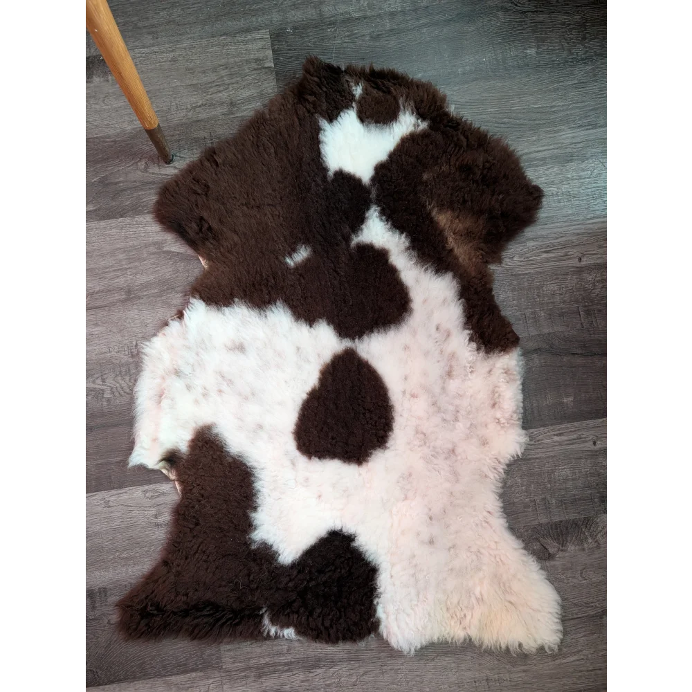 Brown and white highland spotted sheepskin rug with fluffy natural fur texture grade b sheepskins