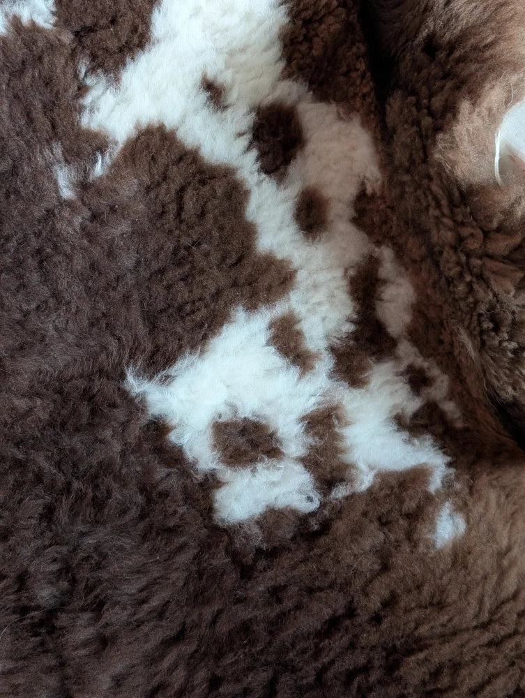 Brown and white fluffy tibet highland spotted sheepskin rug with soft plush texture grade a- sheepskins