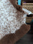 A cozy fluffy brown and white tibet highland spotted grade a- sheepskin rug with a soft textured surface