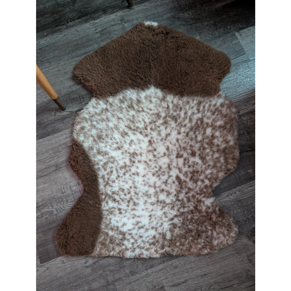 Brown and white tibet highland spotted grade a- sheepskin rug with a natural fluffy texture