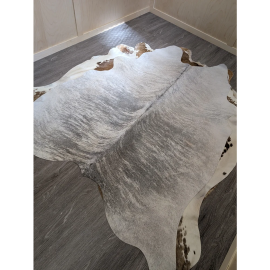 Large cowhide rug 80 x 63 inches with white and gray base brown patches and subtle black speckles perfect for any room