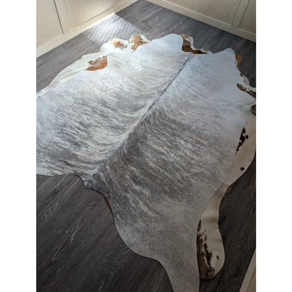 Large cowhide rug with gray and white marbled pattern and brown edge patches extra large cowhide perfect for decor