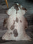 A plush grade a- sheepskin rug with a soft white base and brown splotches from tibet highland spotted collection