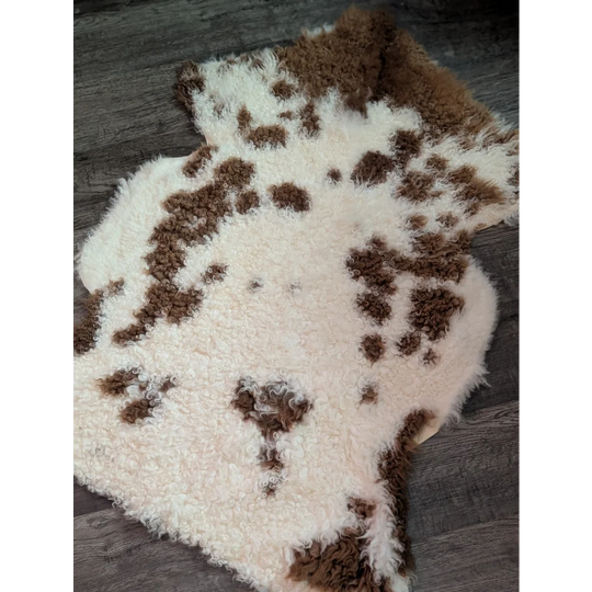 A plush grade a- sheepskin rug with creamy white base and brown patches from tibet highland spotted collection