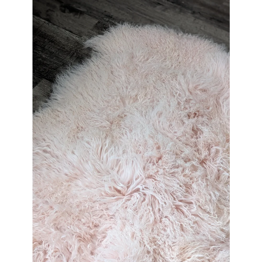 Blush pink 71x47 Angus Oliver sheepskin rug with fluffy curly texture