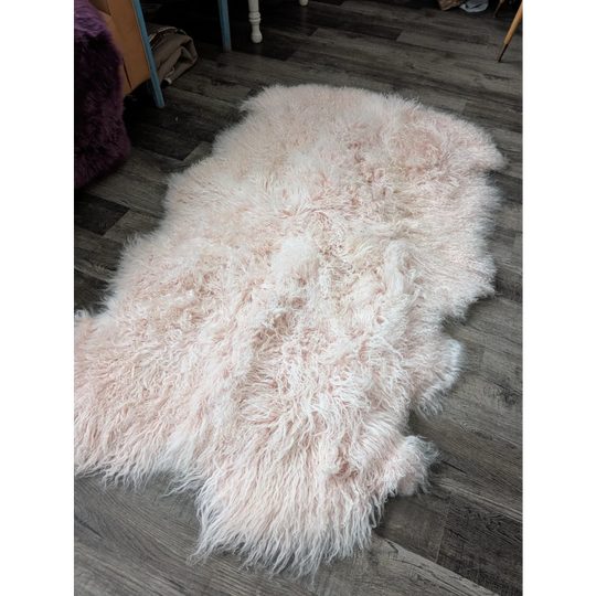 Blush pink Angus Oliver sheepskin rug, 71x47 plush fluffy fibers on wood floor