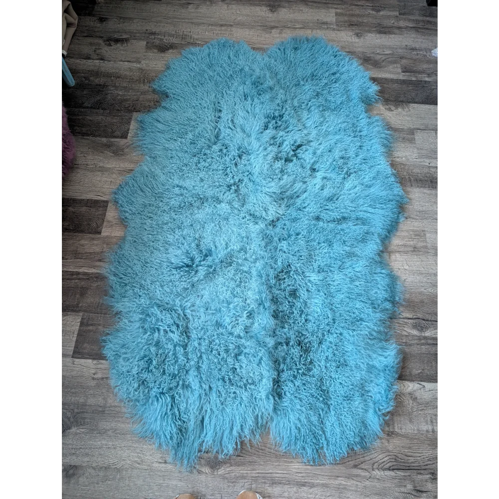 Gorgeous 72x45in aqua Mongolian sheepskin rug on wood floor