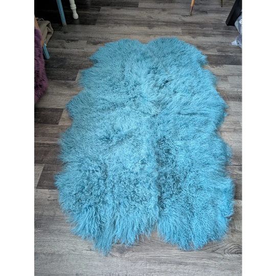 Gorgeous 72x45in aqua Mongolian sheepskin rug on wood floor