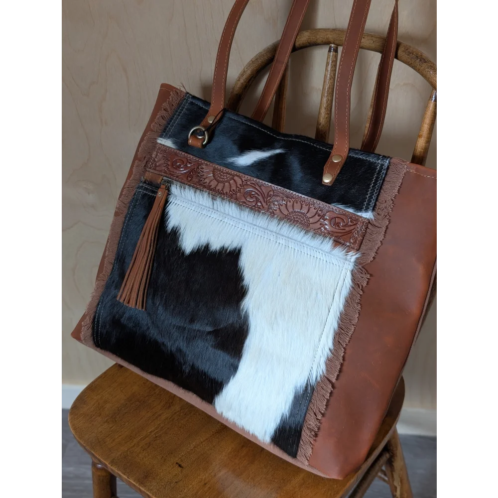 Brown and black real cowhide oakley specks canvas shoulder bag with frayed edges and decorative tooled leather trim