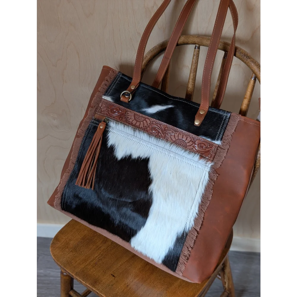 Brown and black real cowhide oakley specks canvas tote bag with fringed edges and floral embossed trim