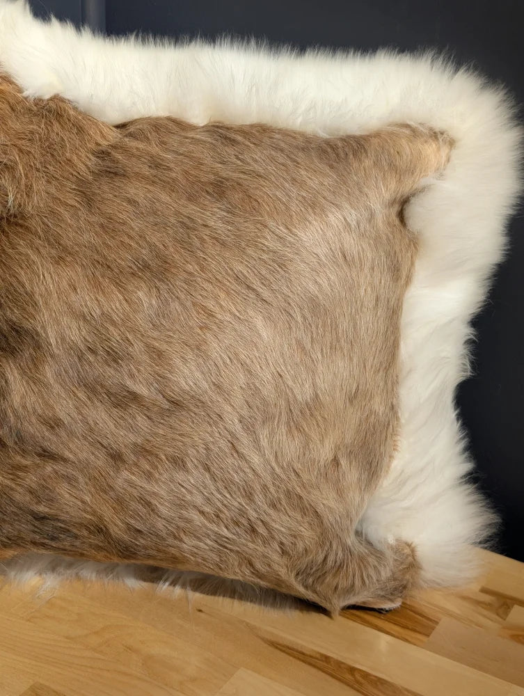 Brown faux fur pillow with white fleece border in a one of a kind cowhide merino sheepskin cushion design