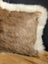 Brown faux fur pillow with white fleece border in a one of a kind cowhide merino sheepskin cushion design