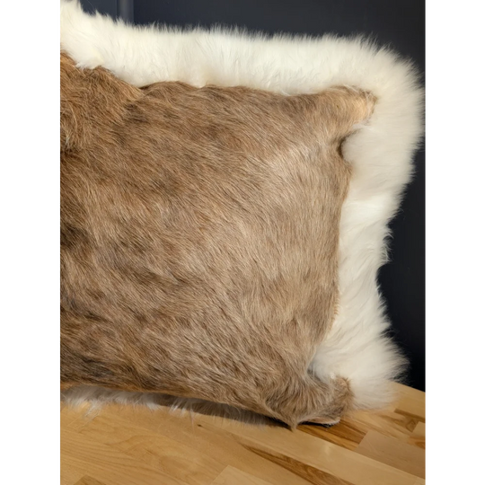 Brown faux fur pillow with white fleece border in a one of a kind cowhide merino sheepskin cushion design