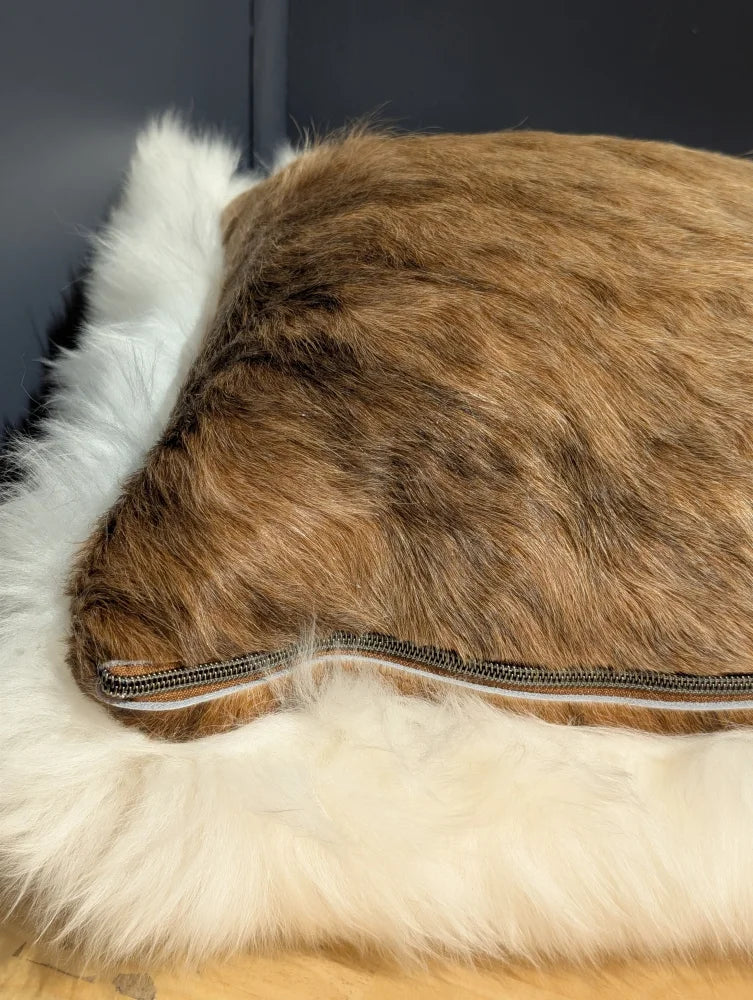 Brown faux fur merino sheepskin cushion with white fluffy trim and visible zipper for cozy cowhide merino sheepskin use