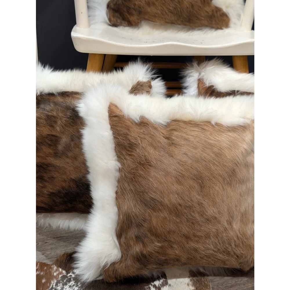 Brown and white one of a kind cowhide merino sheepskin cushion with plush fluffy texture ideal for cozy decor