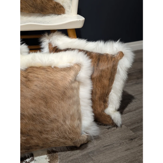 Brown and white cowhide merino sheepskin cushion with fluffy fur trim perfect for cozy home decor
