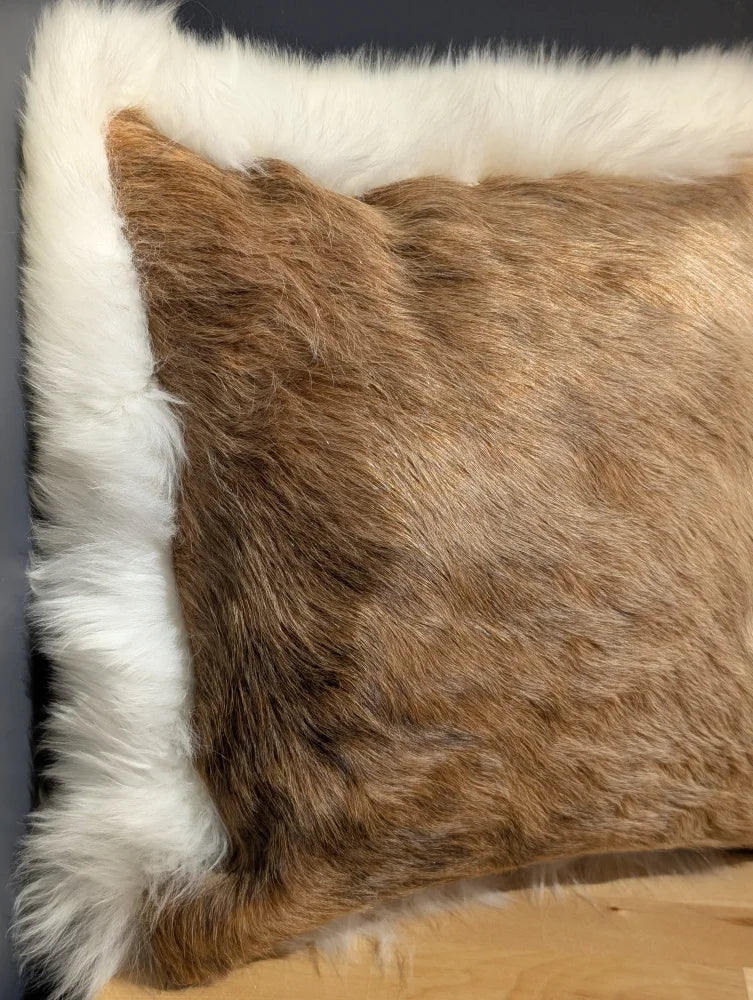 Brown faux fur pillow with white fluffy border in a unique cowhide merino sheepskin cushion design