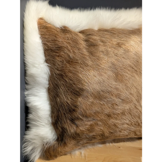 Brown faux fur pillow with white fluffy border in a unique cowhide merino sheepskin cushion design