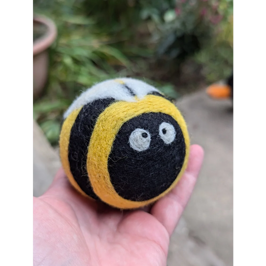 Cute yellow black wool bumble bee dryer ball with googly eyes