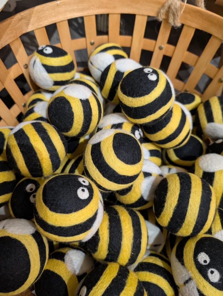 Cute yellow black striped wool bumble bee dryer balls with googly eyes