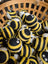 Cute yellow black striped wool bumble bee dryer balls with googly eyes