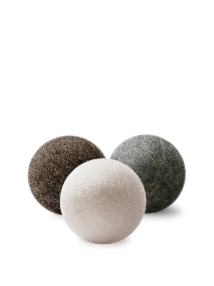 Three wool dryer balls in earthy brown gray and off-white made of wool for eco-friendly drying