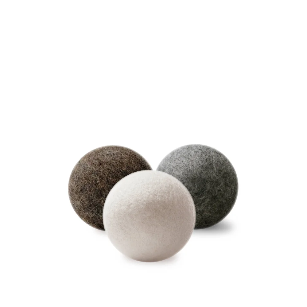 Three wool dryer balls in earthy brown gray and off-white made of wool for eco-friendly drying