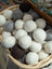 A basket with white and gray fluffy wool dryer balls made from pure merino by moss creek wool