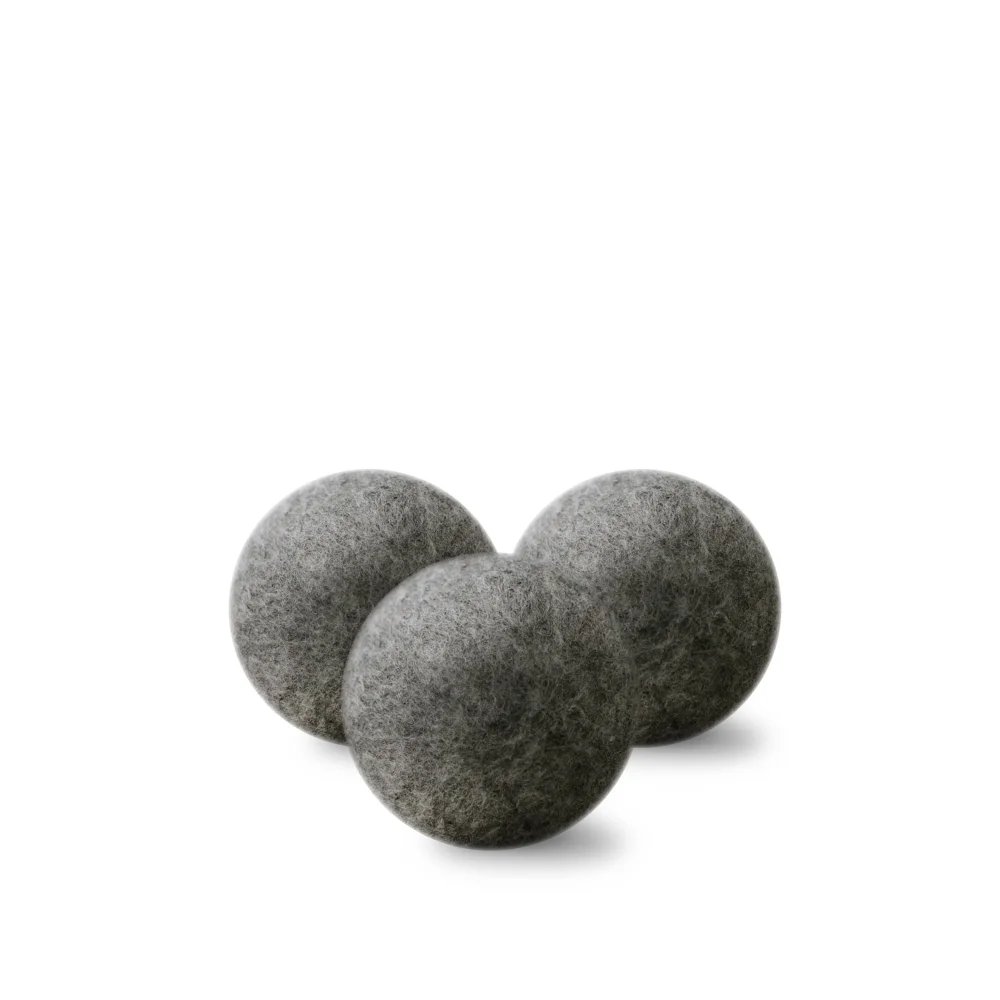 Three matte gray wool dryer balls with soft felt texture for eco friendly laundry use