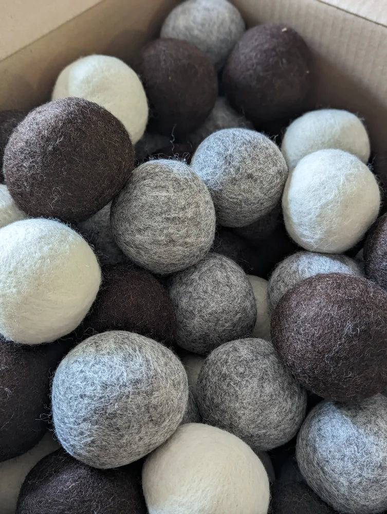 A set of 3 wool dryer balls in white gray and brown made from pure merino by moss creek wool