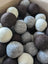 A set of 3 wool dryer balls in white gray and brown made from pure merino by moss creek wool