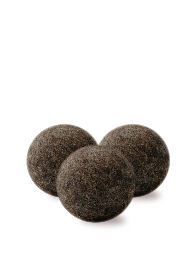 Three dark brown fuzzy wool dryer balls made from natural wool for eco-friendly drying and softening clothes