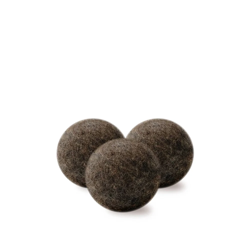 Three dark brown fuzzy wool dryer balls made from natural wool for eco-friendly drying and softening clothes