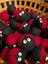 Red and black felt ladybug dryer balls with googly eyes in a woven basket