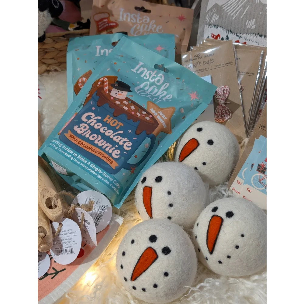Cute wool snowman dryer balls with carrot noses, black eyes, and sheepskin fluff